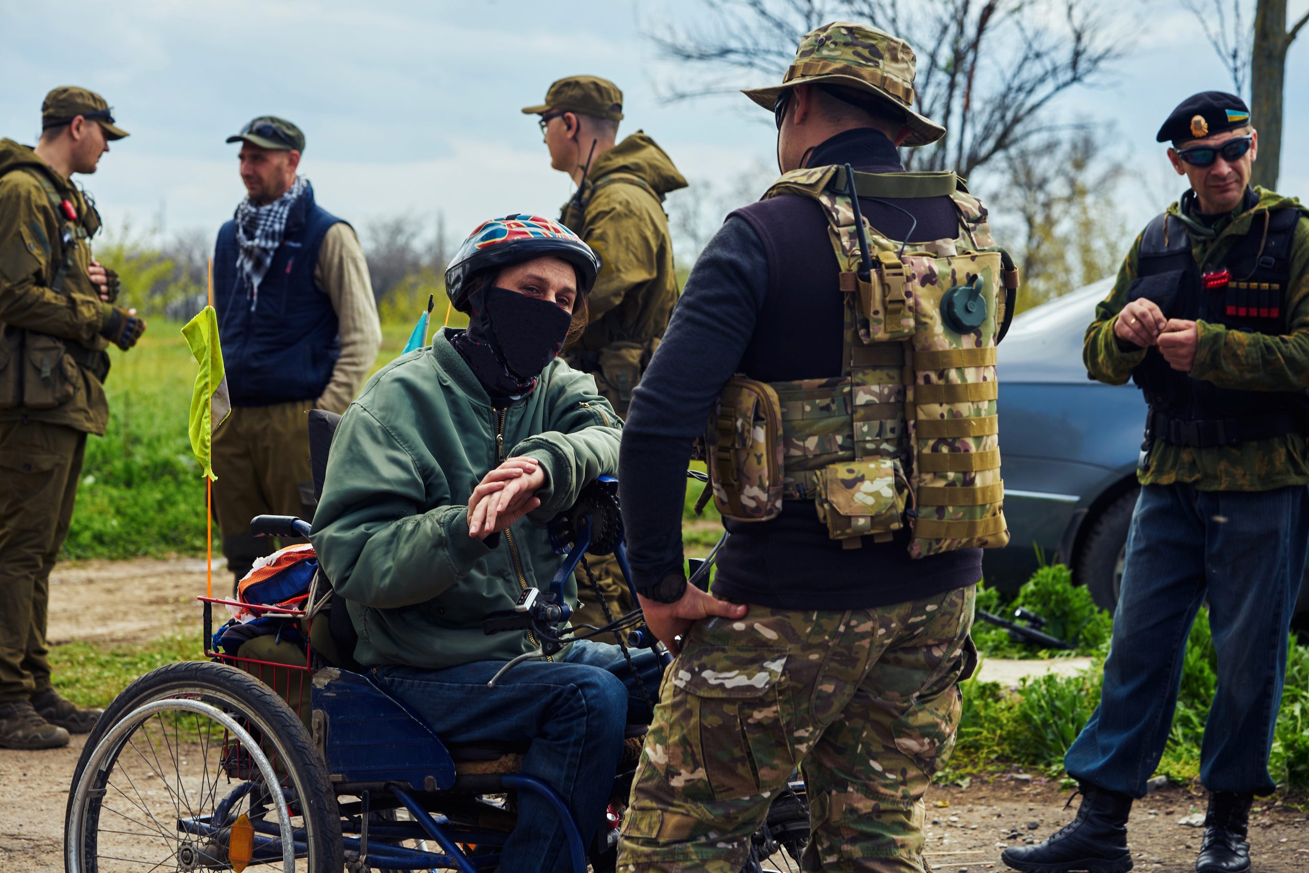 Disabled man in a wheelchair with a group of soldiers